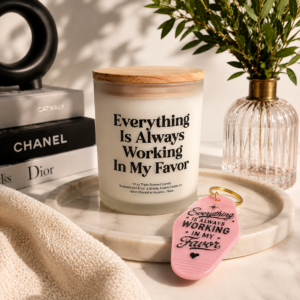 Everything Is Always Working In My Favor Candle next to the retro keychain on a modern table